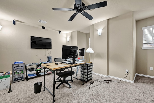 home office featuring a ceiling fan, carpet flooring, visible vents, and baseboards