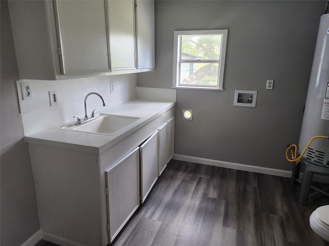 laundry area with laundry area, baseboards, dark wood-style floors, washer hookup, and a sink