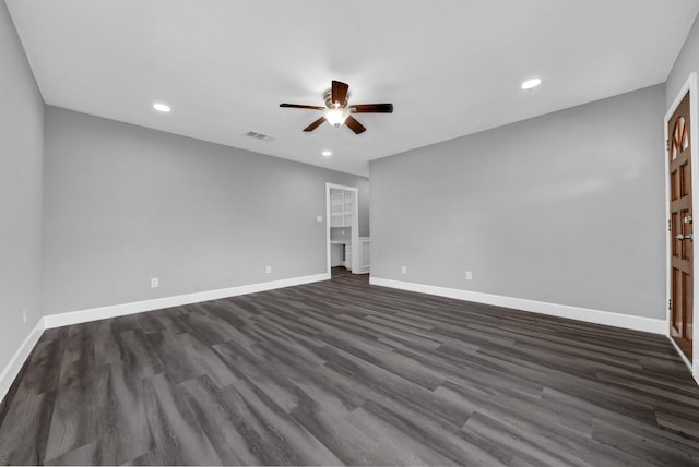 spare room featuring ceiling fan, baseboards, dark wood-type flooring, and recessed lighting