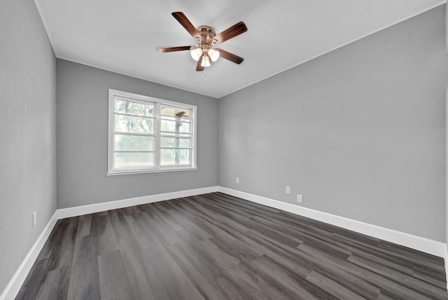 spare room with ceiling fan, baseboards, and dark wood finished floors