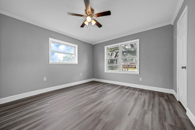 empty room featuring dark wood-style floors, baseboards, a ceiling fan, and ornamental molding