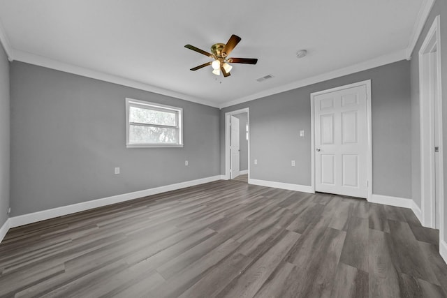 unfurnished bedroom with ceiling fan, wood finished floors, visible vents, baseboards, and crown molding