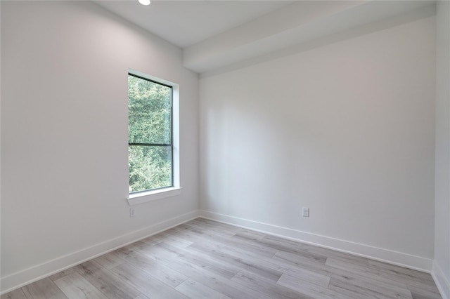 unfurnished room featuring light wood-type flooring and baseboards