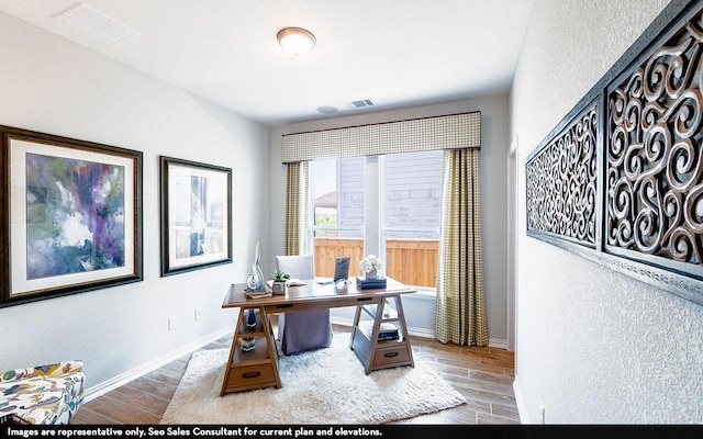 home office with wood finish floors and baseboards