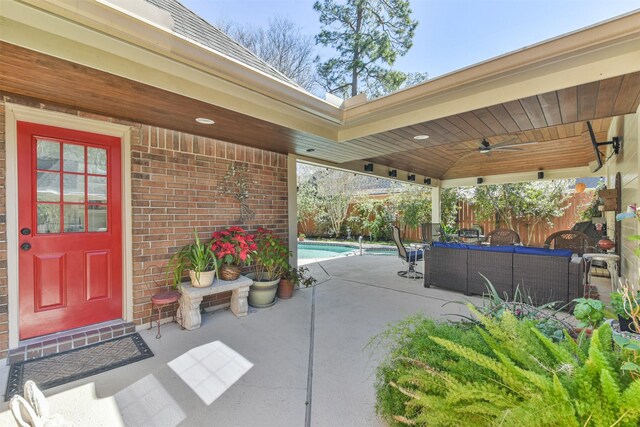 view of patio / terrace featuring an outdoor pool, outdoor lounge area, ceiling fan, and fence