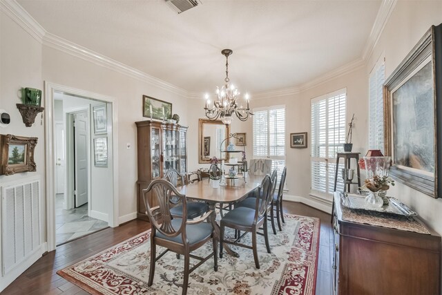 dining area with ornamental molding, visible vents, and dark wood finished floors