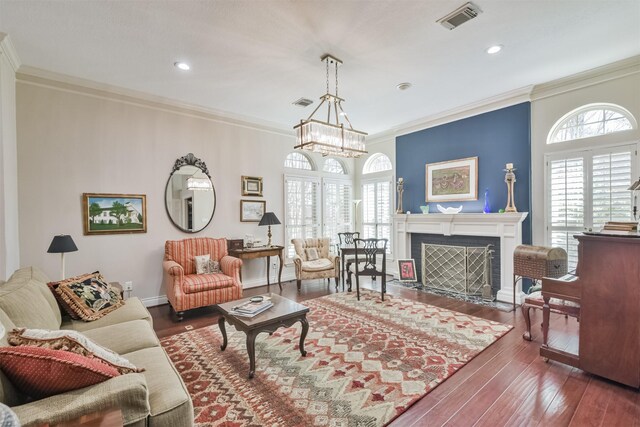 living area featuring a fireplace with flush hearth, visible vents, and ornamental molding