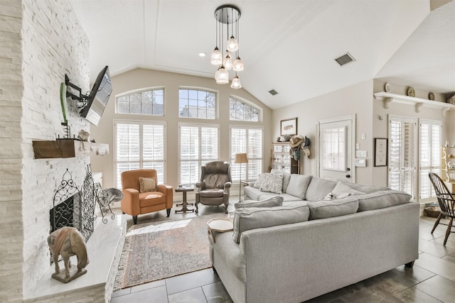 living room featuring a large fireplace, visible vents, and tile patterned floors