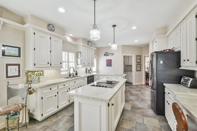 kitchen featuring black appliances, a kitchen island, white cabinetry, and a sink