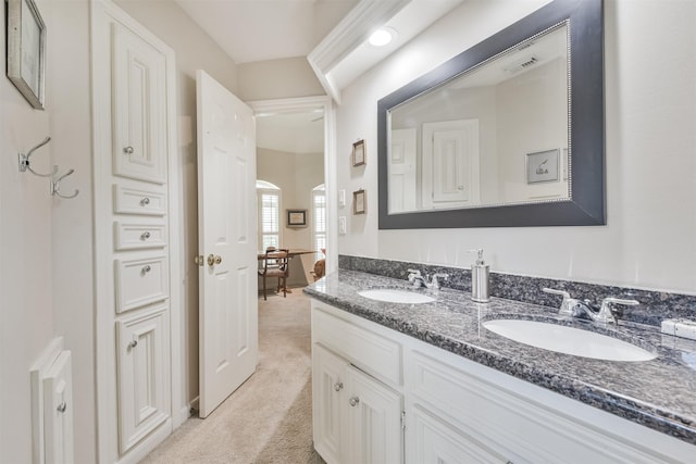 bathroom with visible vents, a sink, and double vanity