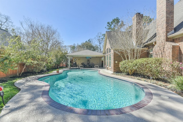 view of swimming pool with a patio area, fence, and a fenced in pool