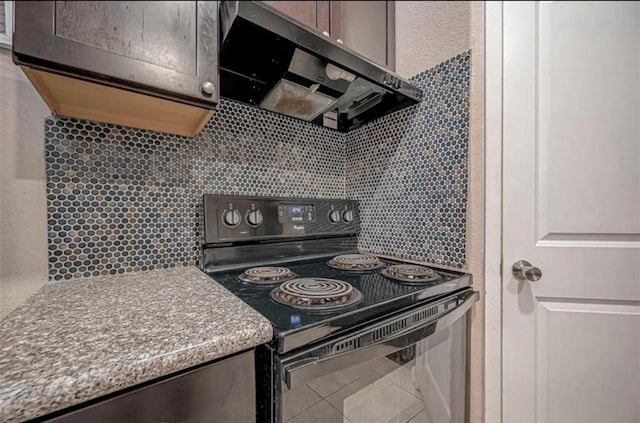 kitchen with tasteful backsplash, ventilation hood, black electric range oven, and light countertops