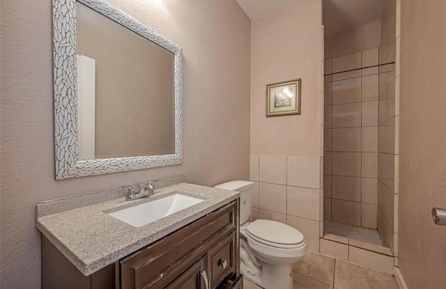 full bath featuring a walk in shower, vanity, toilet, and tile patterned floors