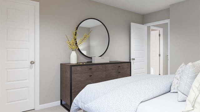 bedroom featuring light colored carpet and baseboards