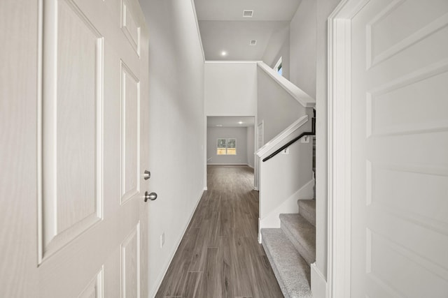 foyer featuring recessed lighting, dark wood-style flooring, a towering ceiling, baseboards, and stairway