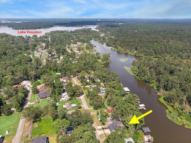 aerial view with a water view and a wooded view