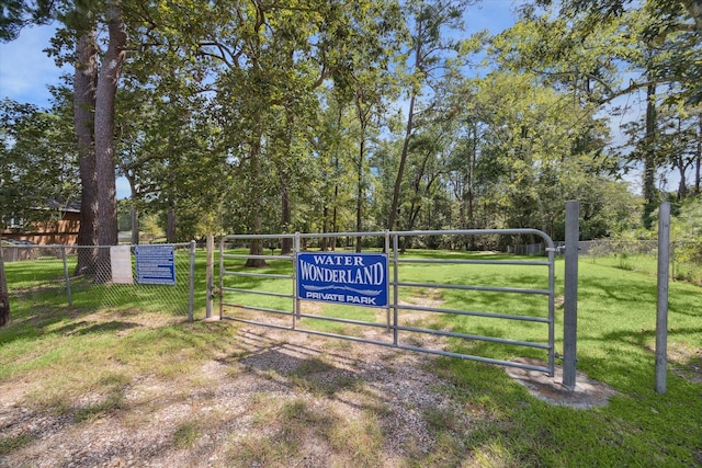 view of home's community with a gate, fence, and a yard