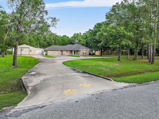 view of front facade featuring a garage, a front yard, and fence