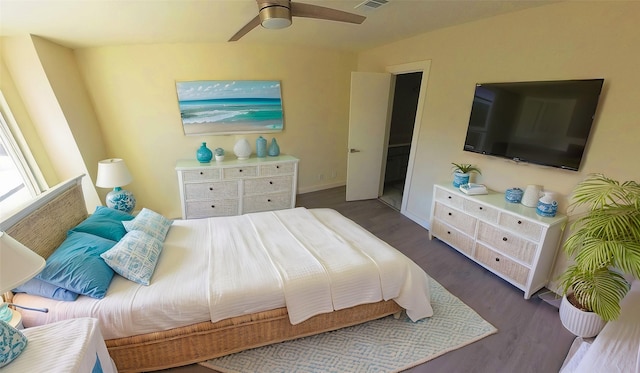 bedroom with a ceiling fan, dark wood-style flooring, visible vents, and baseboards