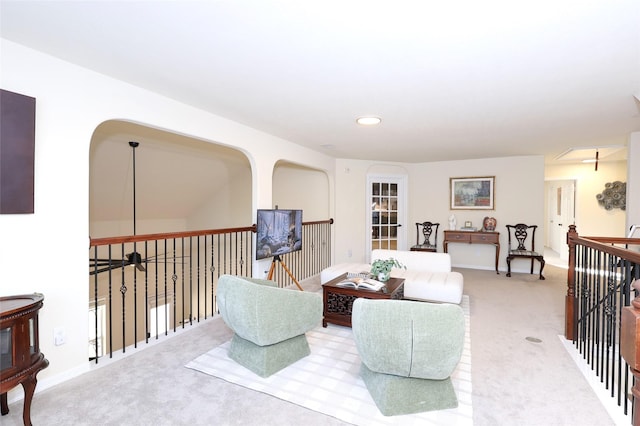 sitting room with carpet floors, an upstairs landing, and recessed lighting