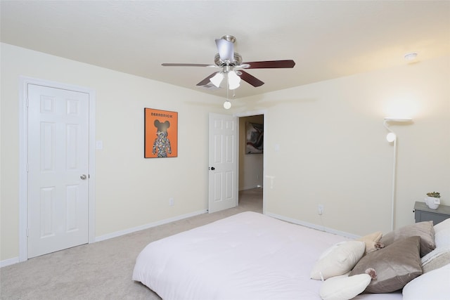 bedroom with ceiling fan, baseboards, and light colored carpet