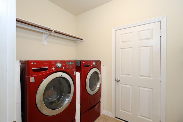 laundry room featuring laundry area, baseboards, and separate washer and dryer