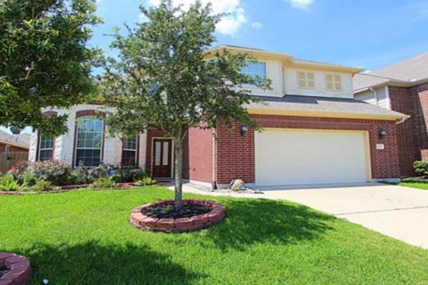 26631 Fielder Brook Ln, Katy, TX 77494 - view of front of house featuring an attached garage, brick siding, concrete driveway, and a front yard