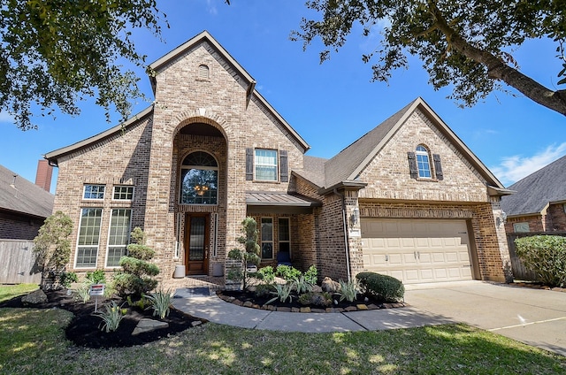 view of front of home featuring brick siding, a standing seam roof, fence, a garage, and driveway