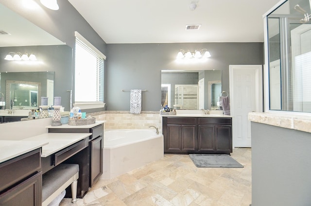 bathroom featuring visible vents, a shower stall, vanity, and a bath