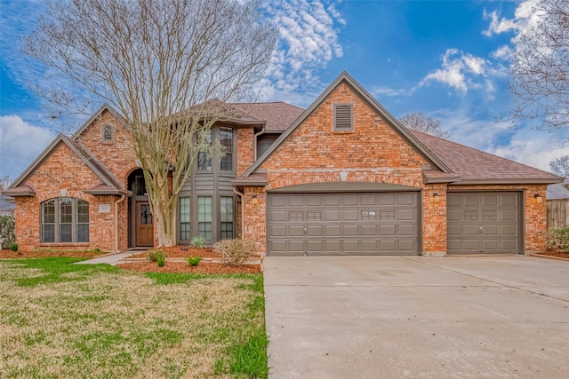 traditional home featuring concrete driveway, brick siding, an attached garage, and roof with shingles