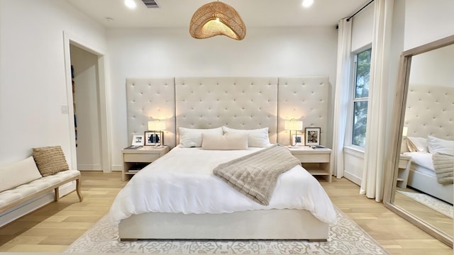 bedroom with light wood-style floors, recessed lighting, visible vents, and baseboards