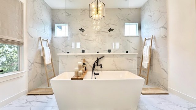 full bathroom with marble finish floor, a marble finish shower, and a wealth of natural light