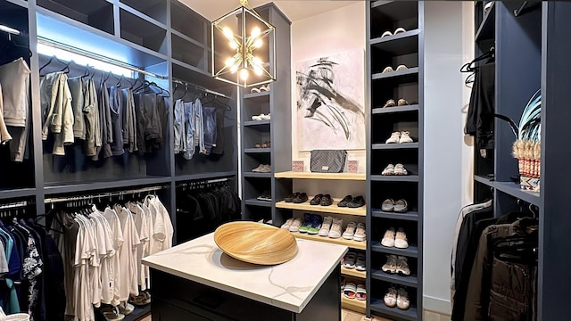 spacious closet featuring a chandelier