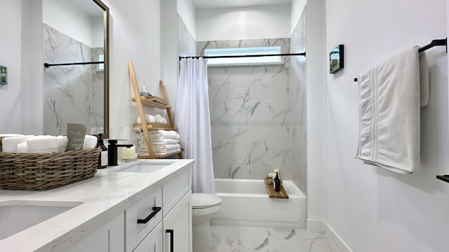 full bath with marble finish floor, shower / tub combo with curtain, double vanity, toilet, and a sink