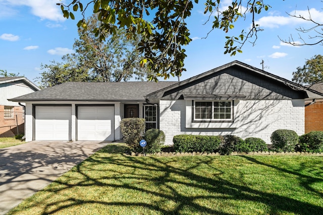 view of front of home with a front lawn, concrete driveway, and brick siding