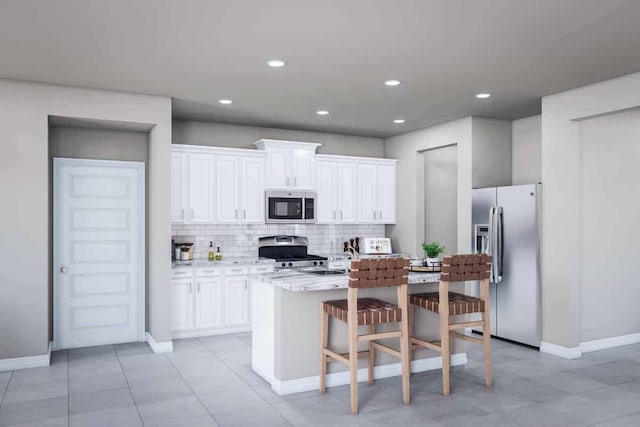 kitchen featuring stainless steel appliances, a breakfast bar, white cabinetry, and an island with sink