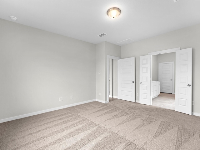 unfurnished bedroom with baseboards, visible vents, and light colored carpet