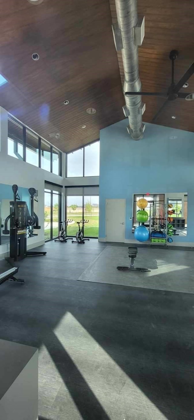 workout area featuring wooden ceiling, a towering ceiling, and recessed lighting