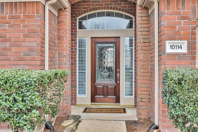 property entrance with brick siding