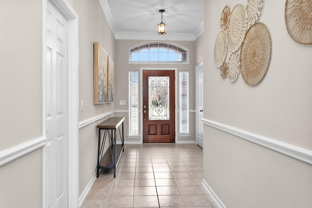 entryway featuring ornamental molding, light tile patterned flooring, and baseboards