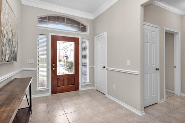 foyer entrance featuring light tile patterned floors, baseboards, and ornamental molding