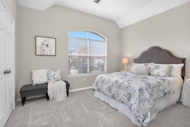 bedroom featuring vaulted ceiling, baseboards, visible vents, and light colored carpet