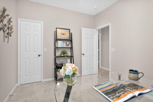 office featuring light carpet and baseboards