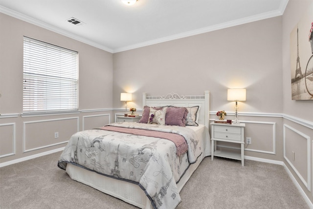 bedroom with light carpet, ornamental molding, visible vents, and a decorative wall