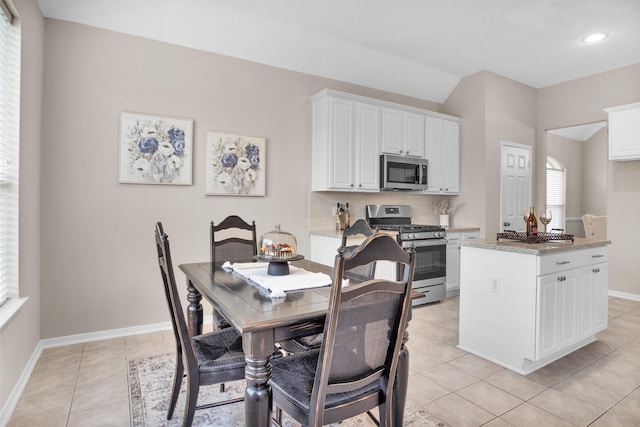 dining room with recessed lighting, baseboards, and light tile patterned flooring