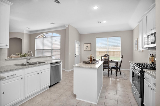 kitchen featuring stainless steel appliances, a sink, and white cabinets