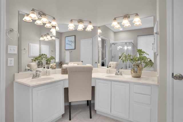 full bath featuring a stall shower, two vanities, and a sink