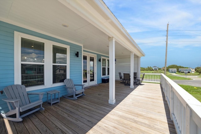 deck with outdoor dining area and french doors