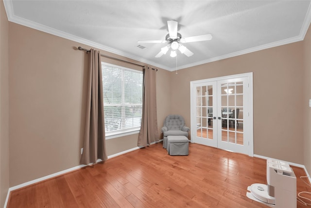 unfurnished room with light wood finished floors, french doors, visible vents, and crown molding