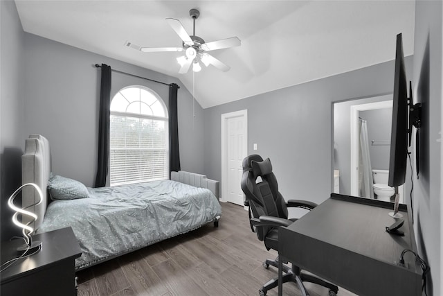 bedroom with lofted ceiling, ceiling fan, wood finished floors, visible vents, and radiator heating unit